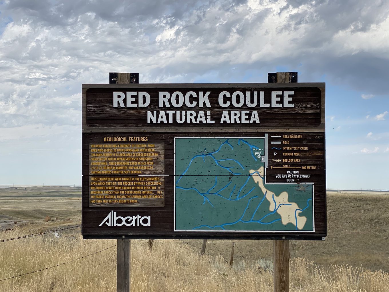 Red Rock Coulee Natural Area entrance sign with geological information and trail map